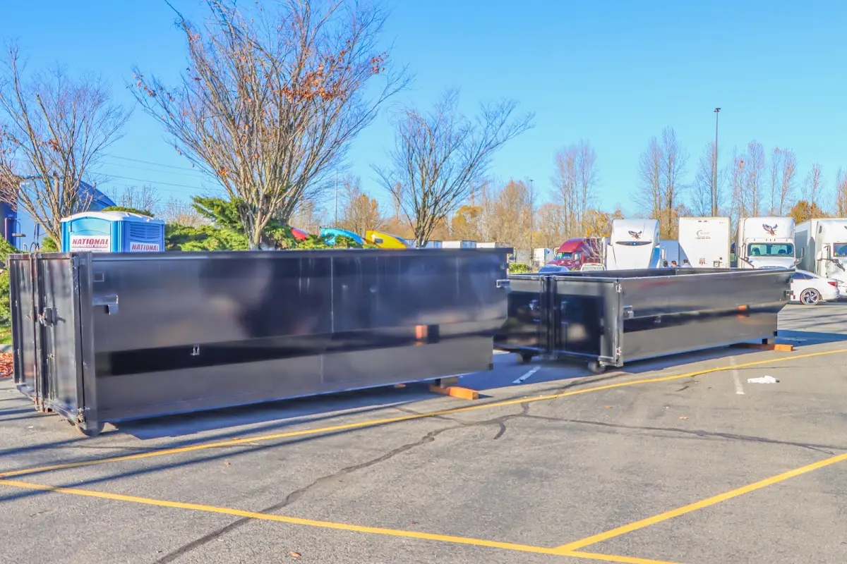 Professional dumpster rental service with roll-off container on residential driveway in Warrensburg
